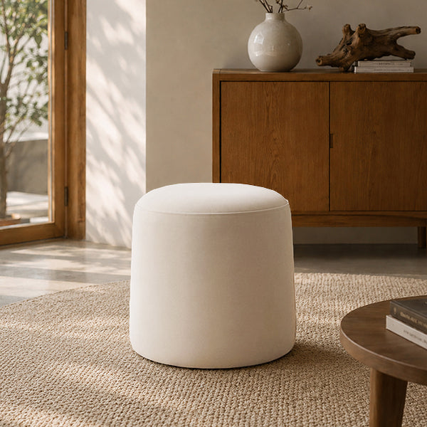 Warm Ivory upholstered ottoman stool in a modern living room